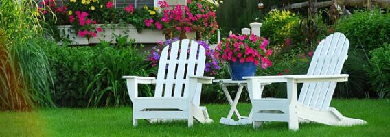 Two lawn chairs in a beautifl garden